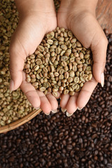 Close up of coffee beans on hand