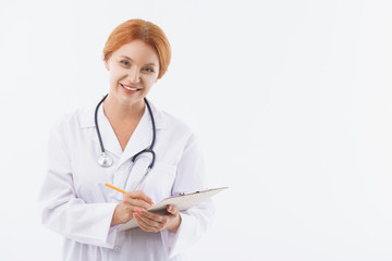 Joyful female physician working with pleasure