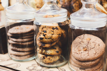 Cookies and biscuits in glass jars on bar for sale