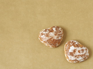 Ginger bread hearts upon “golden” background. Copy space for your text.