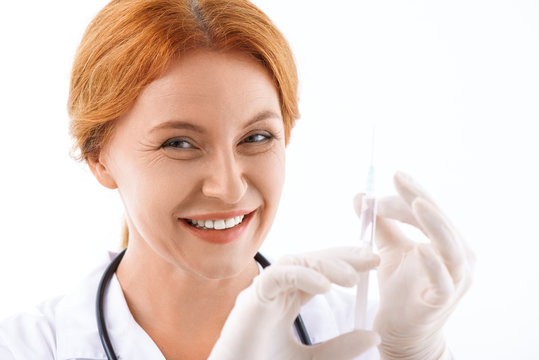 Experienced female doctor preparing for procedure