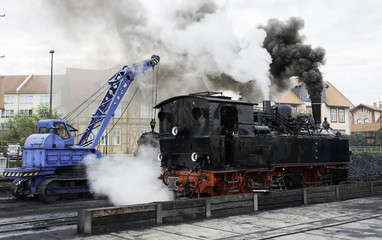 Fototapeta na wymiar crane loading coal into steam loc