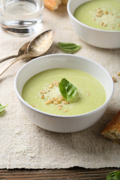 Green soup in white bowl