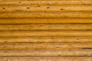 Roundish brown and yellow wooden logs, background