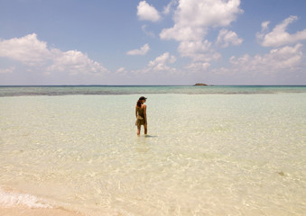 Beautiful shore in Karimunjawa island with girl that walk in the water
