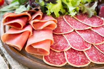 Antipasto with ham, salami and bresaola. tomato and basil. selec