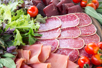Antipasto with ham, salami and bresaola. tomato and basil. selec
