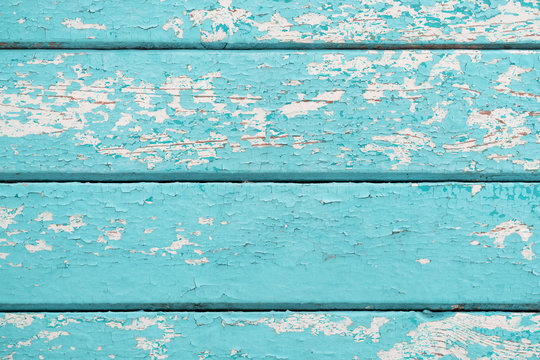 Old wooden planks with cracked blue paint