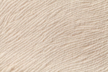 Ivory background from soft textile material. Fabric with natural texture.