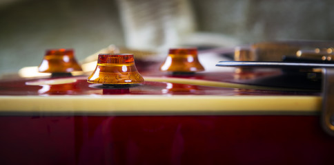 Red acoustic guitar close up in dark background