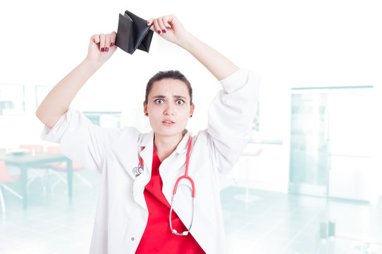 Woman Doctor Looking Shocked By Her Empty Wallet