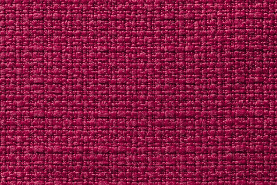 Dark red background from a textile material. Fabric with natural texture. Backdrop.
