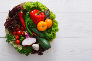 Border of fresh vegetables on wooden background with copy space
