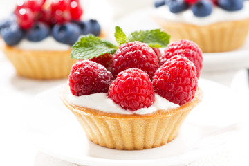 mini tarts with cream and berries, closeup