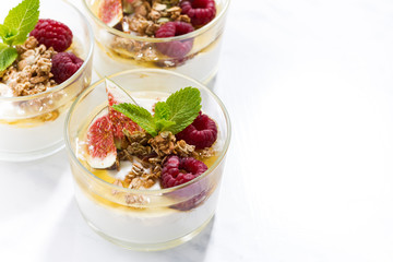 yogurt with honey and fresh figs on white table, top view