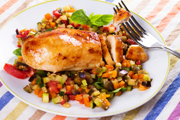 Fried chicken breast with sauteed vegetables: eggplant, carrot, zucchini, squash and tomatoes