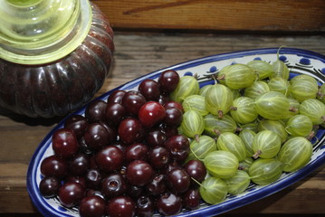 berries, cherries and gooseberries on a plate, jam - 122029616