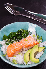 Salmon with spinach and avocado. Rice as a garnish