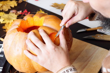 Carving out a pumpkin to prepare halloween lantern