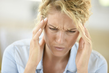 Middle-aged woman suffering headache