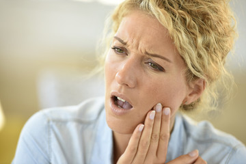 Middle-aged woman suffering toothache