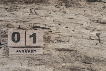 Cube calendar for january on wooden background with copy space