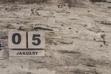 Cube calendar for january on wooden background with copy space