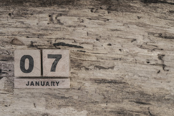 Cube calendar for january on wooden background with copy space
