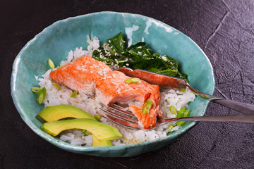 Salmon with spinach and avocado. Rice as a garnish