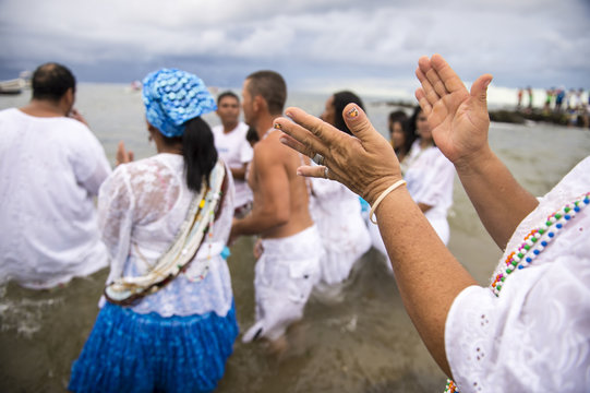Worshippers clapping in motion blur at the Festival of Yemanja in Salvador, Bahia, Brazil 