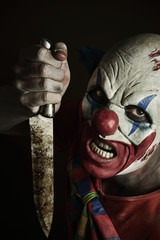 scary evil clown with a knife
