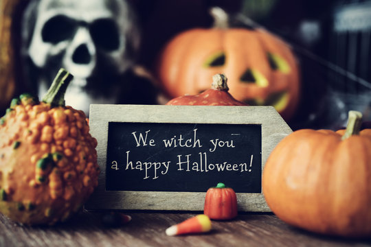 text We witch you a happy Halloween in a chalkboard
