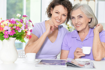 Senior woman with daughter with magazine
