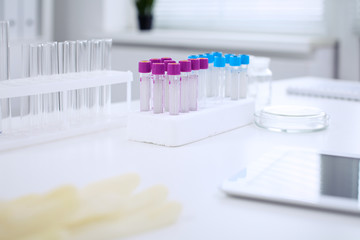 Research laboratory working space. Test tubes and tablet PC are lying at the table. Medical equipment. Blood test