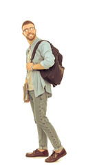 A male student with a school bag holding books isolated on white background