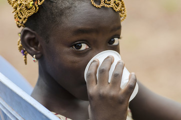 Drinking Water for Life - African Girl drinks water out of a cup