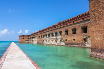 Fototapeta na wymiar Northern Side of Fort Jefferson on Dry Tortugas National Park, Florida. The brick moat around Fort Jefferson with the crystal clear waters of the Gulf of Mexico surround it.