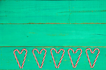 Candy cane shaped hearts on bright green background