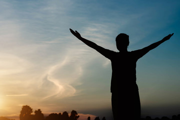 Fototapeta premium silhouette of woman pointing with finger in sky
