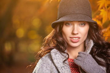 Fashion woman walking in autumn park