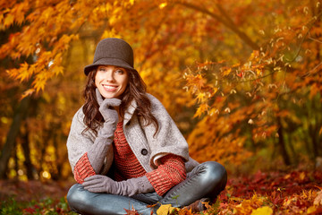 Fashion woman walking in autumn park