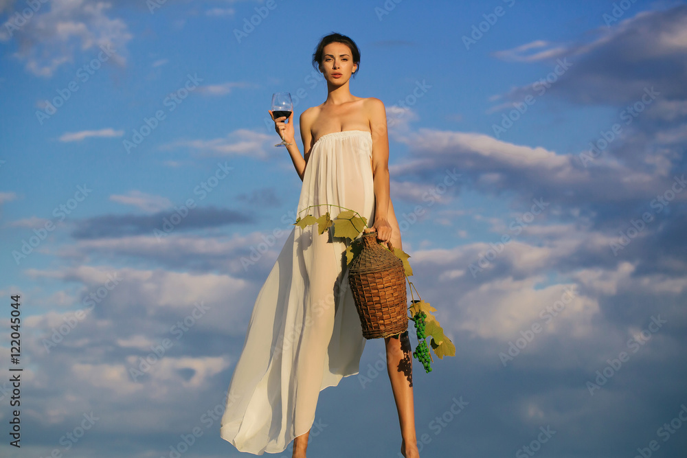 Wall mural pretty girl with wine bottle over sky