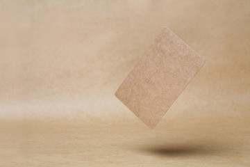 blank business card falling on the brown background