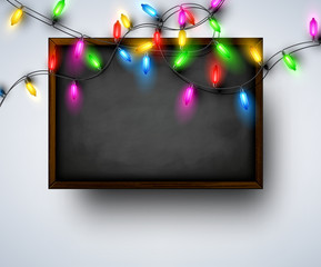Background with blackboard and Christmas garland.