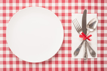  Empty plate and cutlery on a table 
