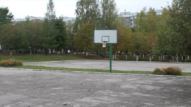 basketball court in the school yard trees in the background