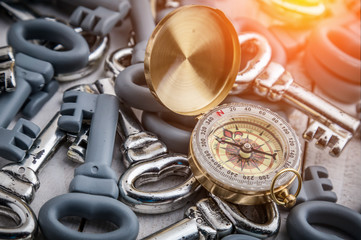 Fototapeta premium business strategy with golden compass and grey and silver keys