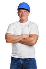 Worker man isolated with helmet and smiling. Crosed arms.