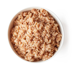 Bowl of buckwheat porridge isolated on white