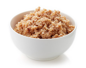 Bowl of buckwheat porridge isolated on white